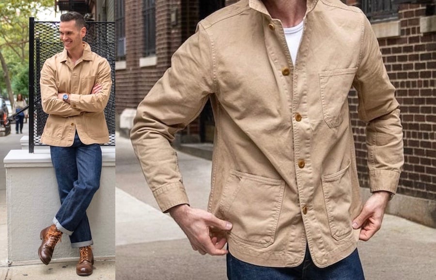 a man modeling a tan chore coat with boots