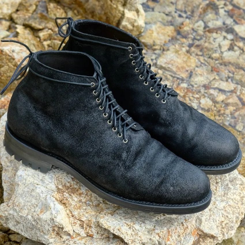 black lost and found boot on stone background