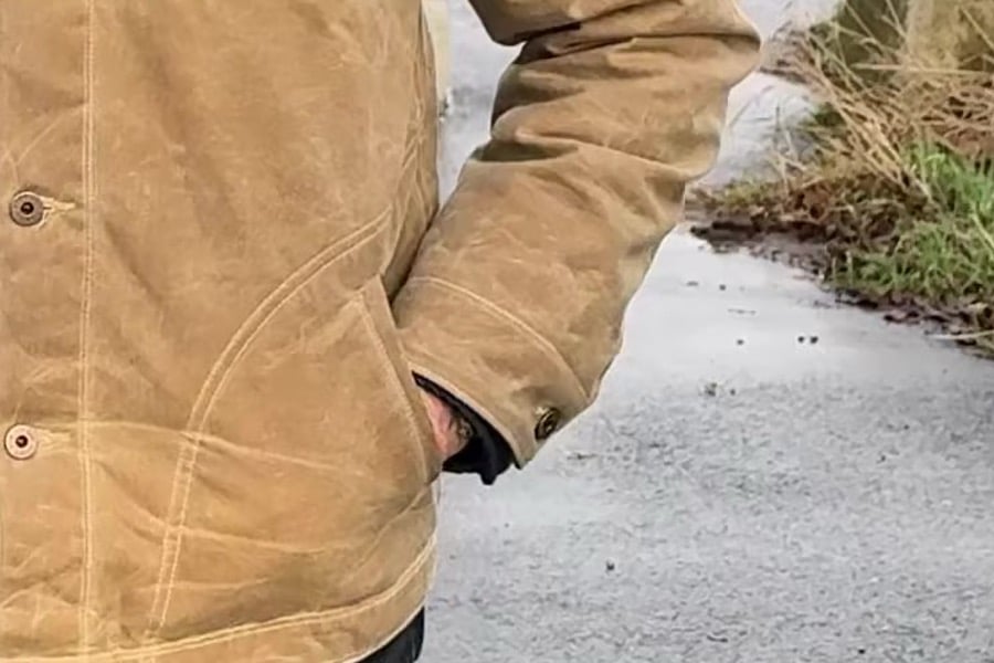 close up view of the author's hand in the handwarmer pocket of Flannel-Lined Quilted Waxed Rancher from Flint and Tinder
