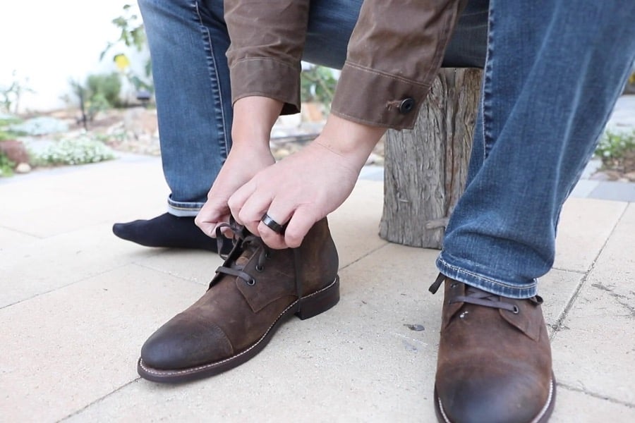 Close up view of author putting on the cadet boots