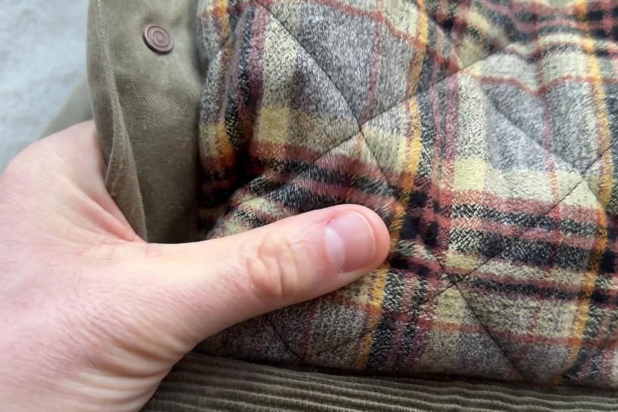 close up view of the flannel lining of Flannel-Lined Quilted Waxed Rancher from Flint and Tinder